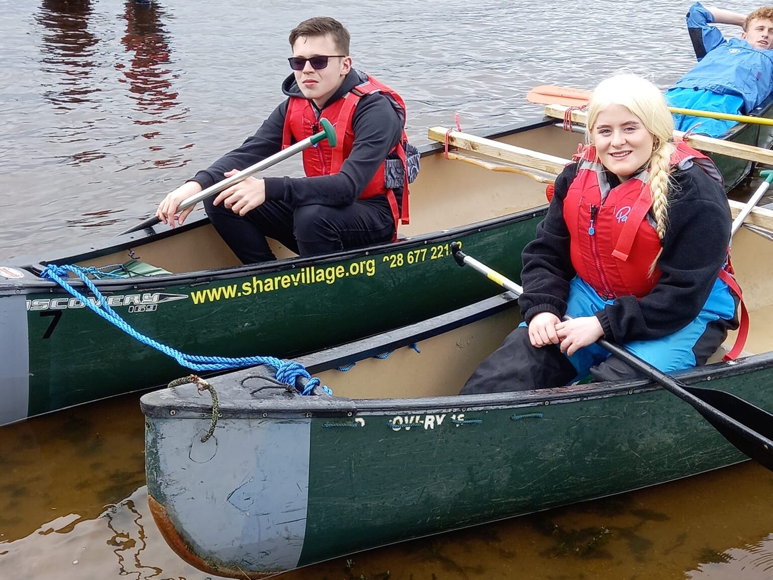 This image shows three teenagers in a canoe taking part in the Angel Eyes residential.